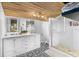 Bathroom featuring dual sinks, a glass-enclosed shower, and stylish black-and-white patterned flooring at 3307 S Manhattan Ave, Tampa, FL 33629