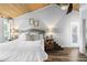 Charming bedroom with wood ceiling, featuring a cozy bed and ample natural light at 3307 S Manhattan Ave, Tampa, FL 33629