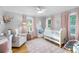 Cozy Bedroom with a crib, soft rug, and natural light streaming through the windows at 3307 S Manhattan Ave, Tampa, FL 33629