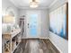 Inviting entryway featuring stylish decor, a modern front door, and beautiful wood-look flooring at 3307 S Manhattan Ave, Tampa, FL 33629
