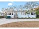 Charming one-story home with blue siding, a paved driveway, and mature trees, perfect for peaceful living at 3307 S Manhattan Ave, Tampa, FL 33629