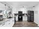 Bright kitchen with granite countertops, stainless steel appliances, and sleek white cabinetry at 3307 S Manhattan Ave, Tampa, FL 33629