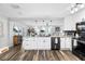 Stylish kitchen featuring white cabinets, granite countertops, and a seamless flow to the living room at 3307 S Manhattan Ave, Tampa, FL 33629