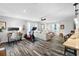 Open-concept living room with modern décor, hardwood floors, and plenty of natural light, adjacent to kitchen at 3307 S Manhattan Ave, Tampa, FL 33629