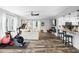Open concept living room featuring a breakfast bar, wood flooring, and a modern ceiling fan at 3307 S Manhattan Ave, Tampa, FL 33629