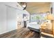 Relaxing main bedroom with a wood ceiling, featuring a sliding glass door and a view into the ensuite bath at 3307 S Manhattan Ave, Tampa, FL 33629