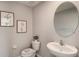 Modern half bathroom with stylish pedestal sink and decorative artwork at 35695 Durand Ct, Zephyrhills, FL 33541