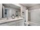 Bright bathroom featuring double sinks, a large mirror, and a shower-tub combo with modern fixtures at 35695 Durand Ct, Zephyrhills, FL 33541
