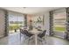 Modern dining room with large windows overlooking the beautiful backyard lake at 35695 Durand Ct, Zephyrhills, FL 33541