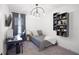 This bedroom features a modern light fixture and a wall-mounted shelf, a desk and a comfortable bed at 3721 Iris N St, St Petersburg, FL 33704