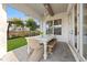 This covered patio features a dining area, neutral decor, and access to a well manicured backyard at 3721 Iris N St, St Petersburg, FL 33704