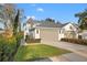 Charming home exterior featuring a well-maintained lawn, attached garages and manicured landscaping at 3721 Iris N St, St Petersburg, FL 33704