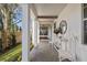 Welcoming front porch with white columns, brick flooring, and stylish decor at 3721 Iris N St, St Petersburg, FL 33704