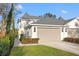 Exterior of home showcasing a two car garage, and well-maintained landscaping at 3721 Iris N St, St Petersburg, FL 33704