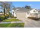 This home showcases a three-car garage with manicured landscaping and a well maintained lawn at 3721 Iris N St, St Petersburg, FL 33704