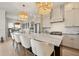 This kitchen features a large center island with seating, modern white cabinets, and elegant pendant lighting at 3721 Iris N St, St Petersburg, FL 33704