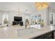 Close-up of kitchen island, highlighting marble countertop, sink, and view of the living room at 3721 Iris N St, St Petersburg, FL 33704