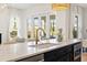 Kitchen island featuring seating, a gooseneck faucet, and view of the backyard at 3721 Iris N St, St Petersburg, FL 33704