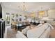Open-concept living room featuring a kitchen island, hardwood flooring, and stylish light fixtures at 3721 Iris N St, St Petersburg, FL 33704