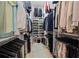 Organized walk-in closet with ample shelving, hanging space, and a stylish rug at 3721 Iris N St, St Petersburg, FL 33704