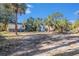 Backyard of home featuring tropical trees and weathered condition of home and land at 4029 13Th S Ave, St Petersburg, FL 33711