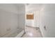 Bathroom featuring white tiled walls, a vintage tub, and a covered window is awaiting renovation at 4029 13Th S Ave, St Petersburg, FL 33711