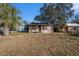 Exterior front view of a single-story house surrounded by a grassy lawn and some trees at 4029 13Th S Ave, St Petersburg, FL 33711