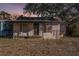 Exterior view of a single-story home with a weathered facade and a small front porch at 4029 13Th S Ave, St Petersburg, FL 33711