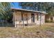 Side view of a single-story house with a small porch and weathered exterior siding at 4029 13Th S Ave, St Petersburg, FL 33711