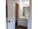 Bright bathroom features a white vanity and a door leading to a toilet and shower area at 4211 Chatham Oak Ct # 122, Tampa, FL 33624