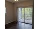 Light-filled bedroom with balcony access and modern dark floors at 4211 Chatham Oak Ct # 122, Tampa, FL 33624