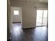 Spacious living room featuring modern flooring, leading to additional rooms and a balcony at 4211 Chatham Oak Ct # 122, Tampa, FL 33624