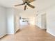 Open floor plan with wood floors, neutral paint, and view to the kitchen at 4215 E Curtis St, Tampa, FL 33610