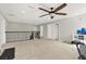 Spacious loft area with carpet, ceiling fan and railing at 4251 Windcrest Dr, Wesley Chapel, FL 33544