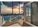 Balcony view overlooking a waterway with palm trees and a vibrant sunset at 4339 Spinnaker Cove Ln, Tampa, FL 33615
