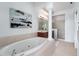 Bright bathroom featuring a soaking tub and walk-in shower at 4339 Spinnaker Cove Ln, Tampa, FL 33615