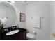 Well-lit bathroom with a dark vanity, elegant fixtures, and a decorative mirror at 4339 Spinnaker Cove Ln, Tampa, FL 33615