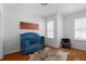A cozy bedroom featuring natural light from large windows, adorned with an American flag and a blue crib at 4339 Spinnaker Cove Ln, Tampa, FL 33615