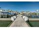 A view down a long pier lined with boat slips and boats on lifts, providing access to waterfront living at 4339 Spinnaker Cove Ln, Tampa, FL 33615