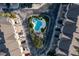 Overhead shot of community pool featuring chaise lounges surrounded by lush green trees at 4339 Spinnaker Cove Ln, Tampa, FL 33615