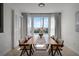 Dining room with large windows, water view, modern table and chairs, and stylish decor at 4339 Spinnaker Cove Ln, Tampa, FL 33615
