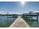 Dock featuring boat lifts, a concrete pathway, and serene water views at 4339 Spinnaker Cove Ln, Tampa, FL 33615