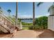 Inviting waterfront deck with a staircase, offering a beautiful view of the canal and well-maintained landscaping at 4339 Spinnaker Cove Ln, Tampa, FL 33615