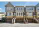 Inviting townhomes featuring private garages and entry stairs, with a classic color palette at 4339 Spinnaker Cove Ln, Tampa, FL 33615