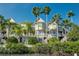 Townhomes in tropical setting featuring multi-story balconies and lush palms by the waterfront at 4339 Spinnaker Cove Ln, Tampa, FL 33615