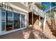 Comfortable outdoor patio area with sliding glass doors, access to the canal, and a stairway at 4339 Spinnaker Cove Ln, Tampa, FL 33615