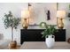 Stylish living room showcasing a dark sideboard with lamps, a modern painting, and decorative plants at 4339 Spinnaker Cove Ln, Tampa, FL 33615
