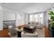 Open living area with hardwood floors, neutral seating, and ample natural light from large windows at 4339 Spinnaker Cove Ln, Tampa, FL 33615