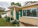 Close-up of inviting home entrance with green door and well-maintained landscaping details at 4640 87Th N Ter, Pinellas Park, FL 33782