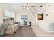 Bright living room with tile floors, a comfortable sofa, chair, and a large decorative rug at 500 86Th N Ave, St Petersburg, FL 33702